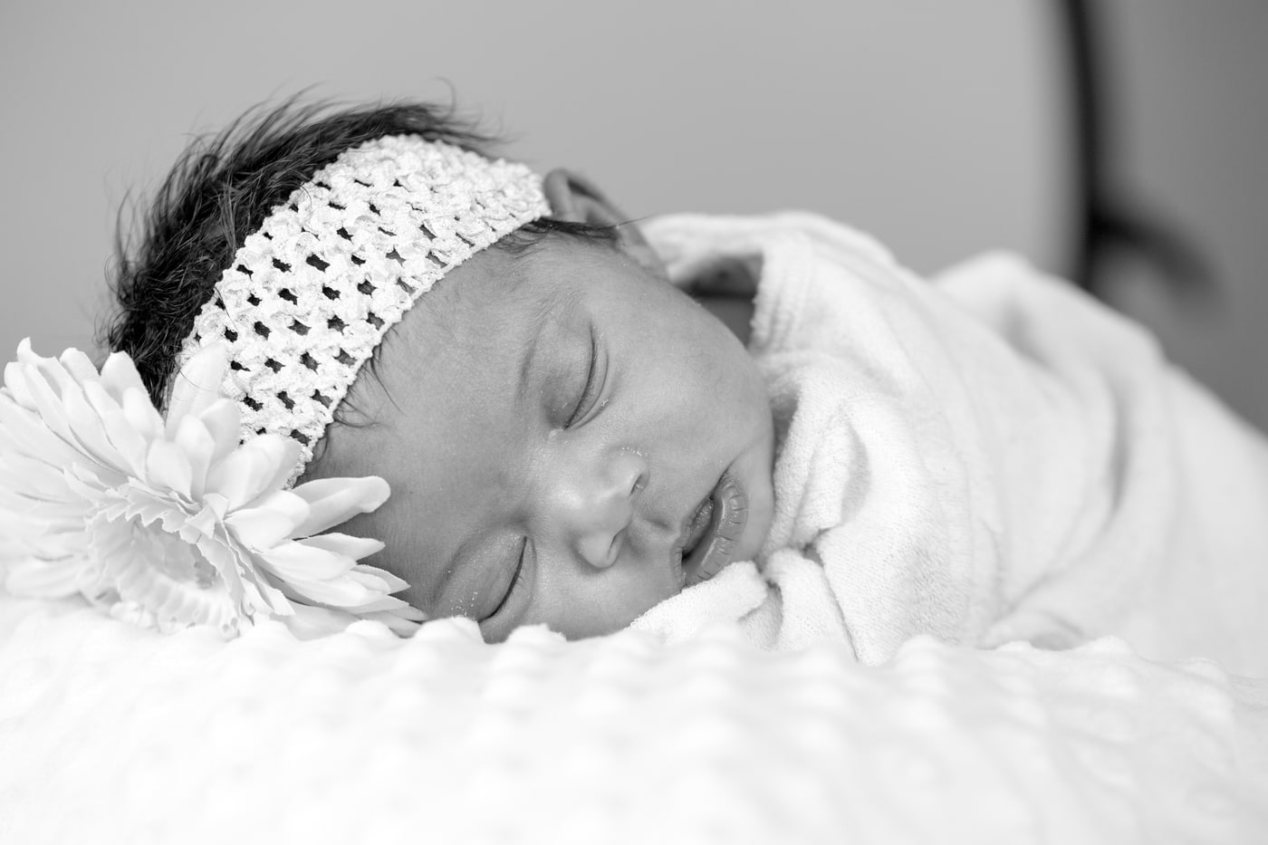 Newborn portrait with quiet black-and-white detail.
