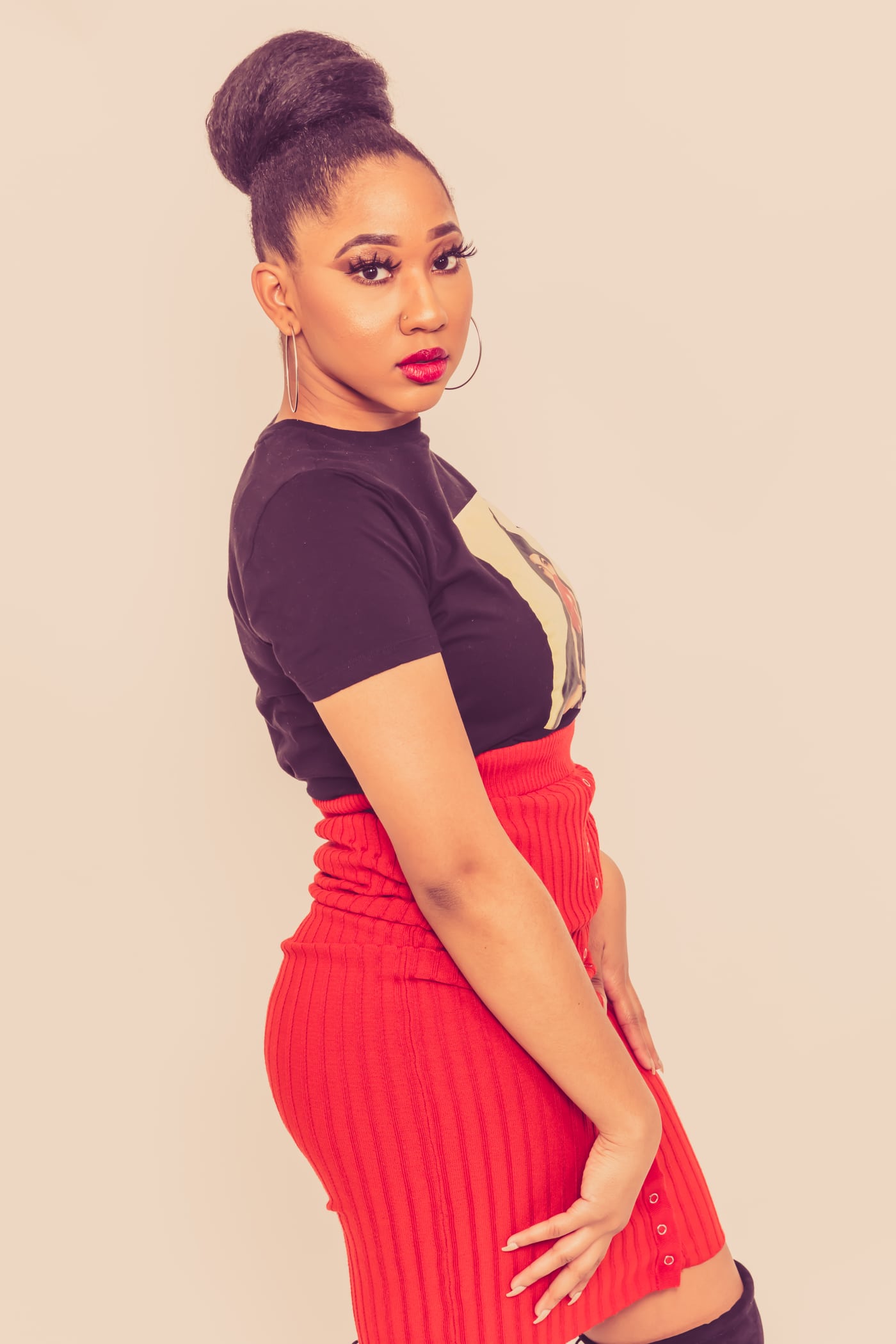 Woman red skirt + black top, updo, fashion.