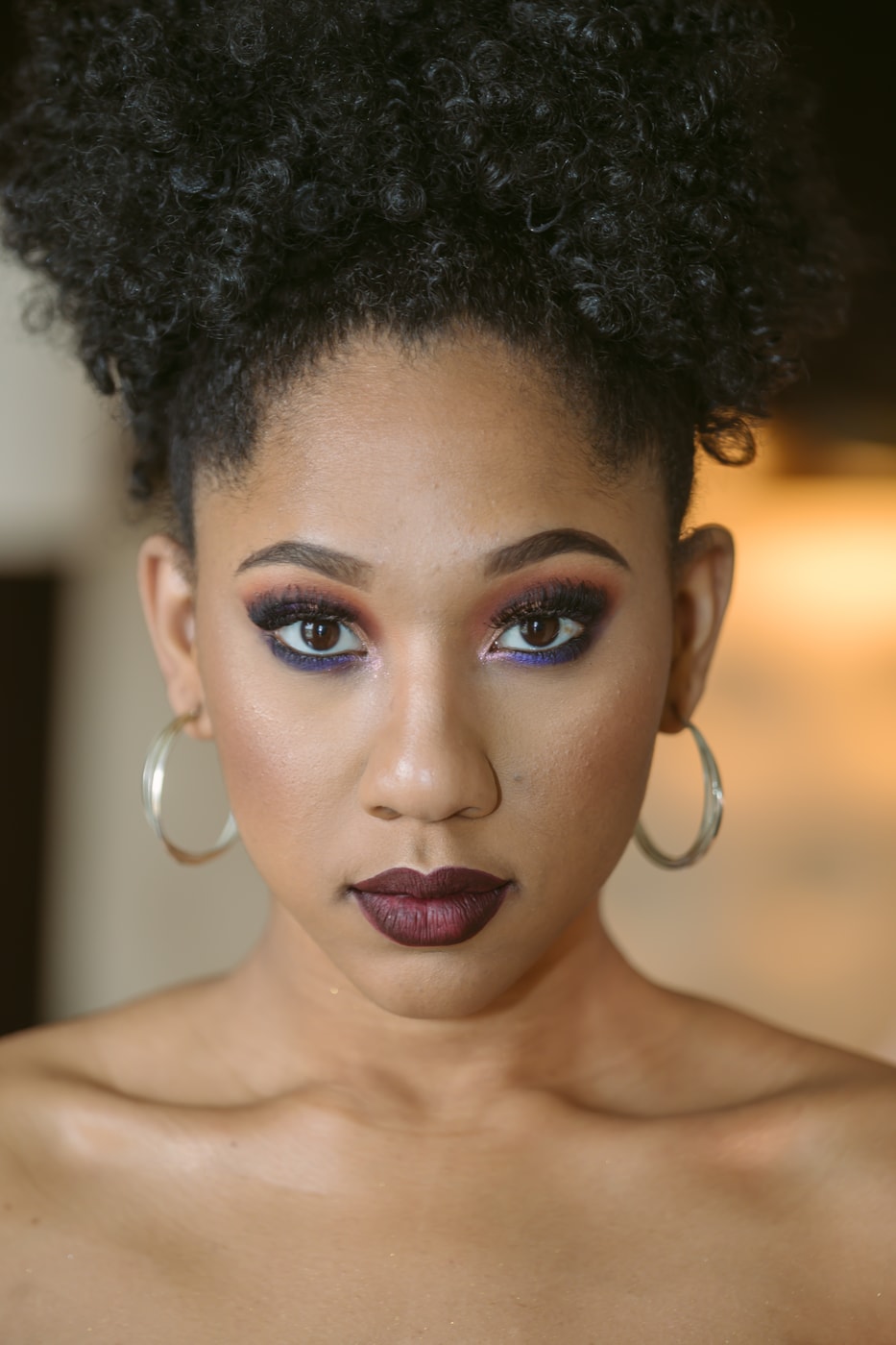 Close editorial headshot, polished makeup.