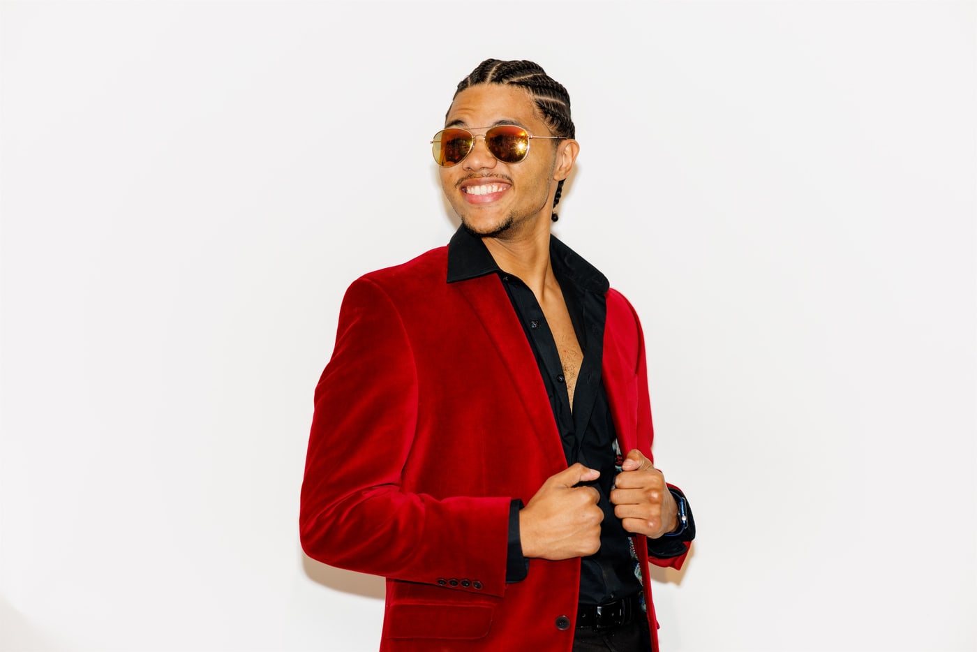 Personal-brand portrait in red blazer on clean white.
