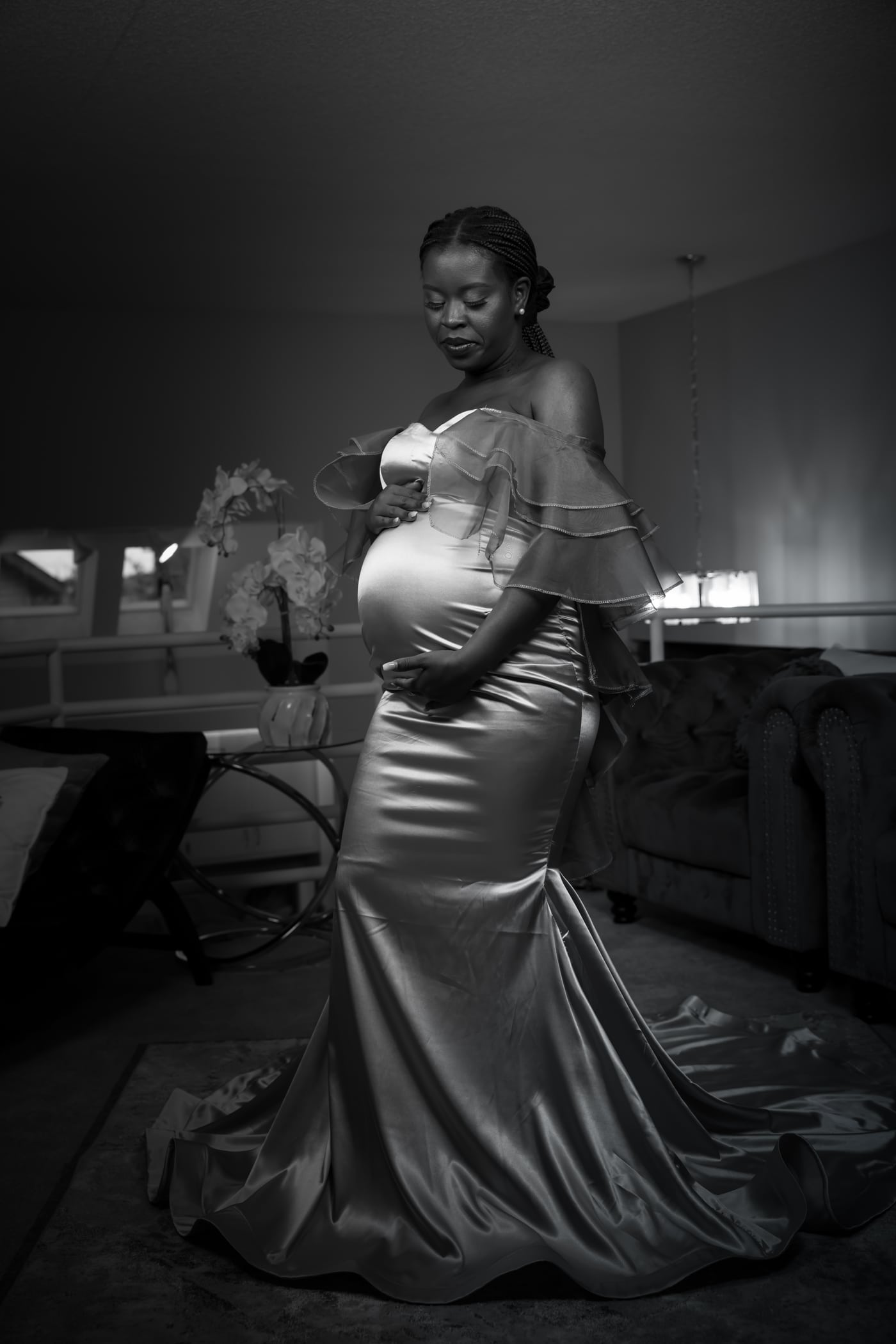 Satin gown, B&W window light, elegant silhouette, editorial maternity.