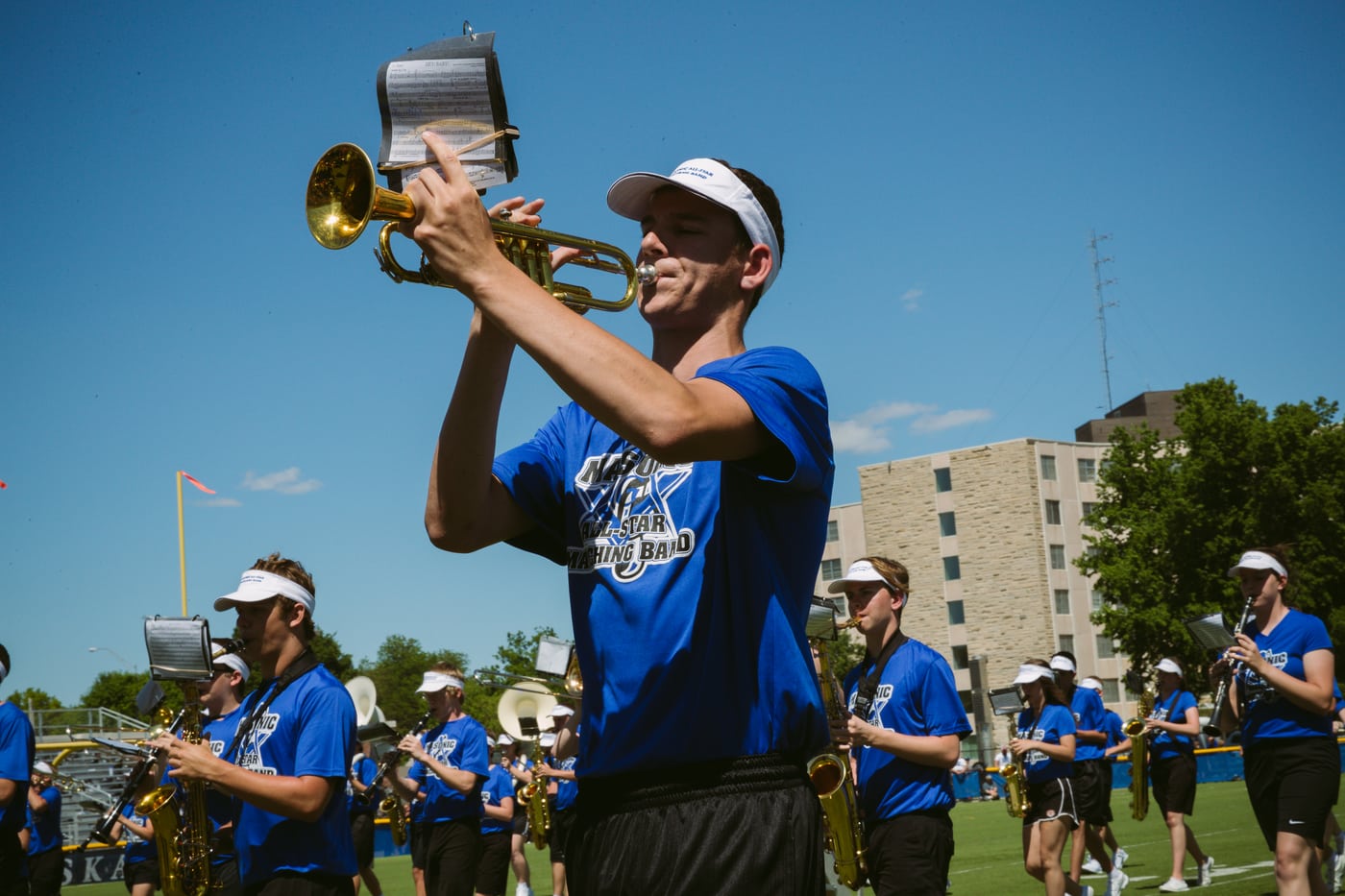 Trumpet player celebrating, spray, music/motion.