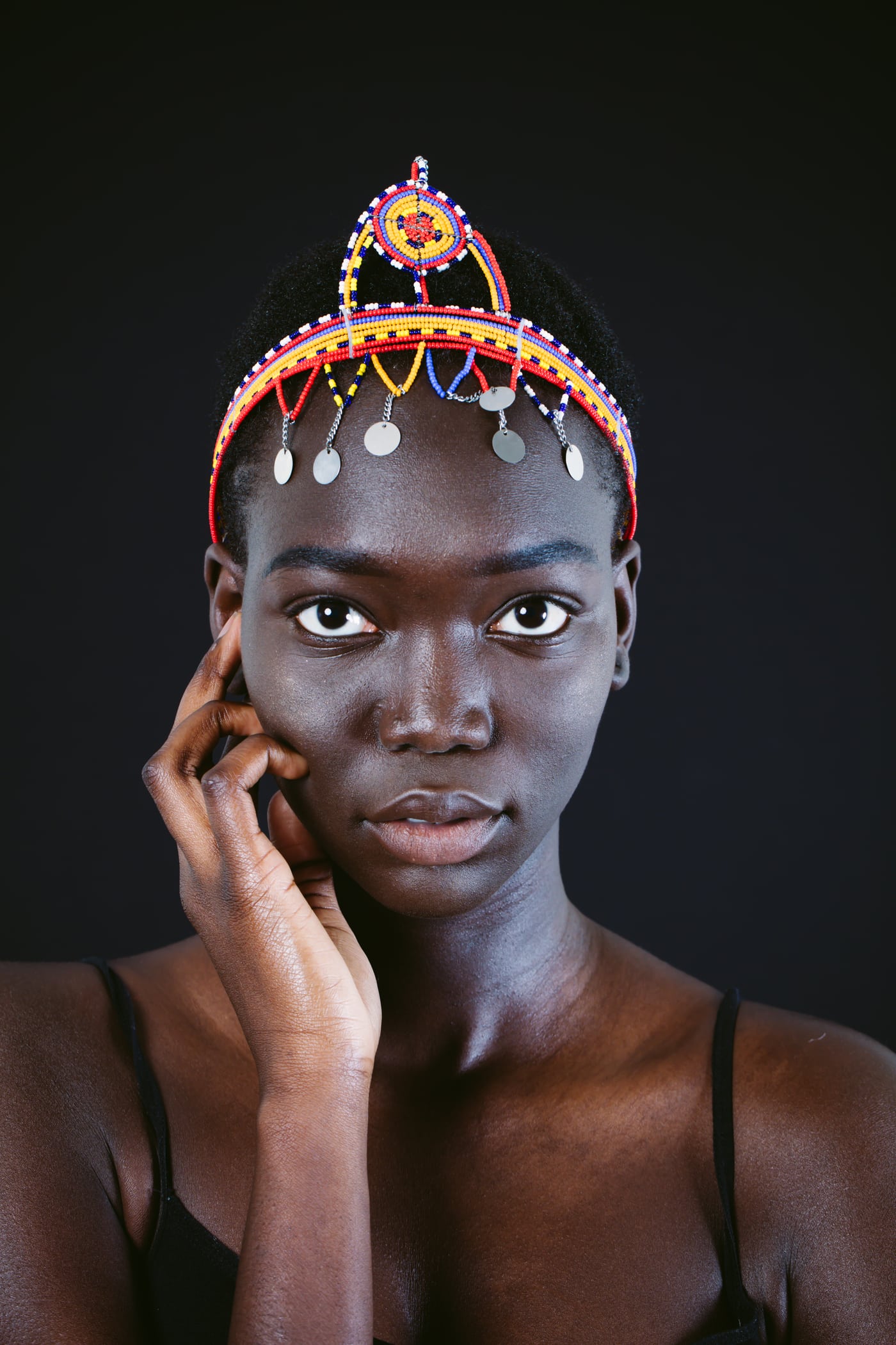Model beaded crown, black top, polished beauty.