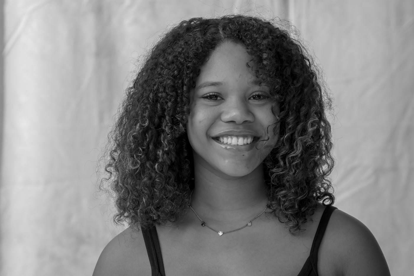 Black-and-white smiling senior portrait.