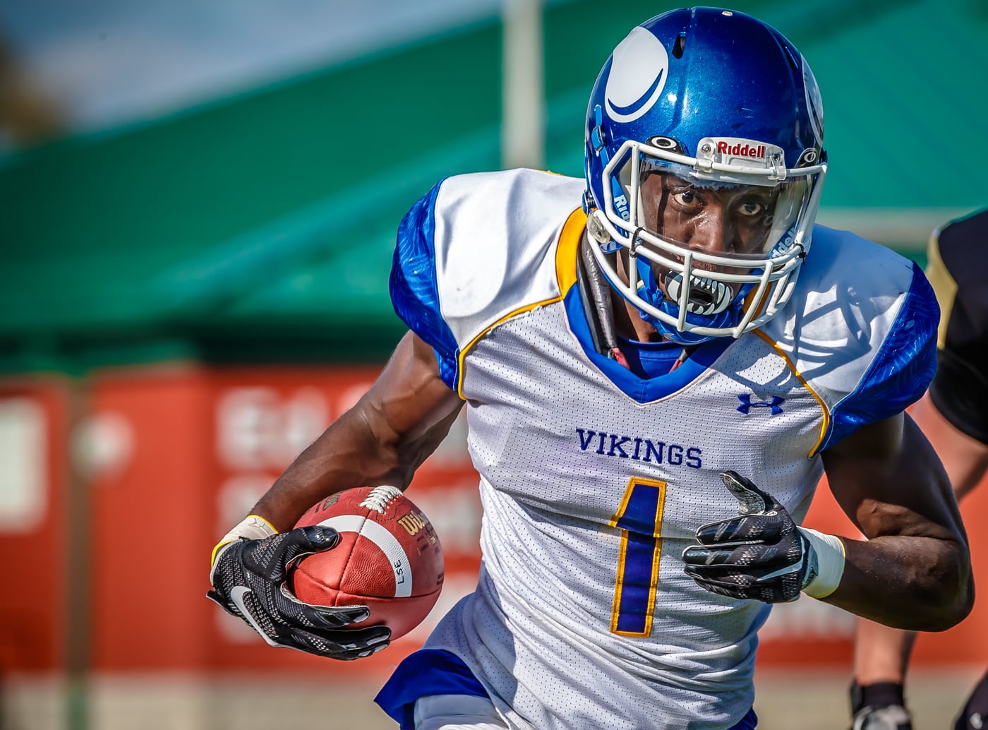 Football Vikings #1 running with ball, strong action.