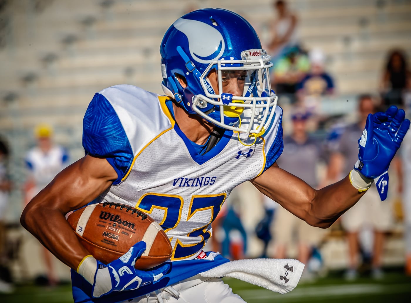Football Vikings #23 running with ball, dynamic.